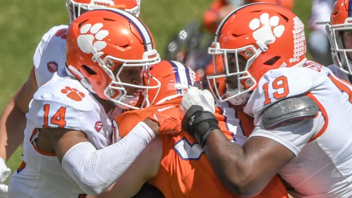 Clemson safety Rob Billings (14) and Clemson defensive lineman DeMonte Capehart (19) tackle Clemsonn running back Tristen Rigby (31) during the fourth quarter of the Spring football game in Clemson, S.C. Saturday, April 6, 2024.