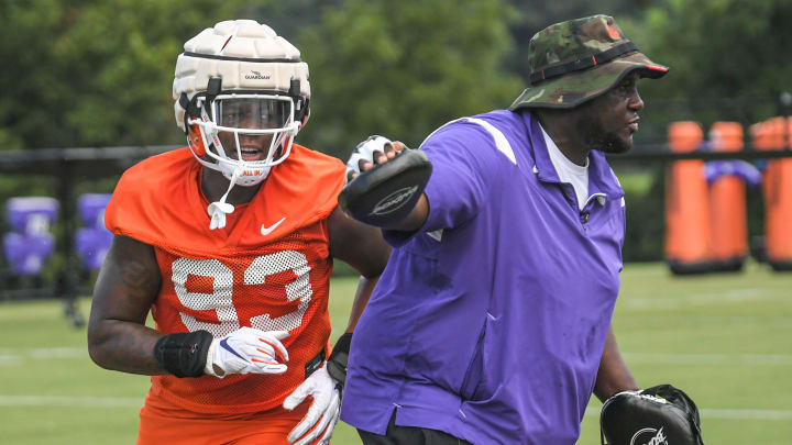Clemson defensive tackle Caden Story (93) runs around defensive tackles Coordinator Nick Eason in a drill during practice at the Poe Indoor Facility in Clemson Monday, August 8, 2022 Clemson defensive tackle Caden Story (93) runs around defensive tackles Coordinator Nick Eason in a drill during practice at the Poe Indoor Facility in Clemson Monday, August 8, 2022