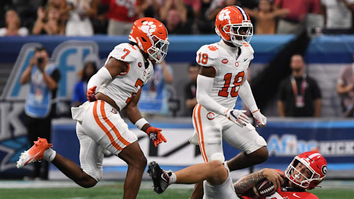 Aug 31, 2024; Atlanta, Georgia, USA; Clemson Tigers safety Khalil Barnes (7) and safety Kylon Griffin (18) run by Georgia Bulldogs quarterback Carson Beck (15) on the ground during the first quarter of the 2024 Aflac Kickoff Game at Mercedes-Benz Stadium. Aug 31, 2024; Atlanta, Georgia, USA; Clemson Tigers safety Khalil Barnes (7) and safety Kylon Griffin (18) run by Georgia Bulldogs quarterback Carson Beck (15) on the ground during the first quarter of the 2024 Aflac Kickoff Game at Mercedes-Benz Stadium.