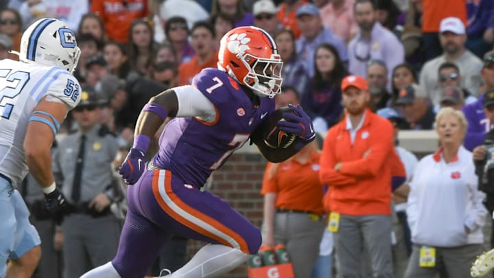 Nov 23, 2024; Clemson, South Carolina, USA; Clemson Tigers running back Phil Mafah (7) runs by The Citadel Bulldogs linebacker Camden Gray (52) during the first half at Memorial Stadium. 