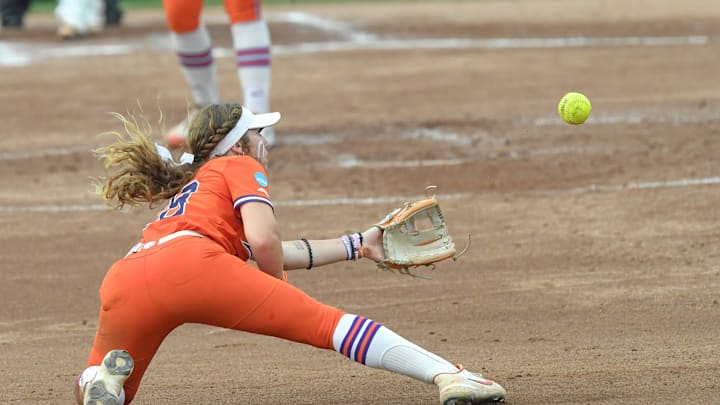 Clemson senior Maddie Moore (28) dishes a ball she dove for toward Clemson freshman Marian Collins (5) to force out USC Upstate junior Aimie Johnson (30) during the top of the fifth inning of the NCAA Softball Tournament Clemson Regional at McWhorter Stadium in Clemson Friday, May 16, 2025.
