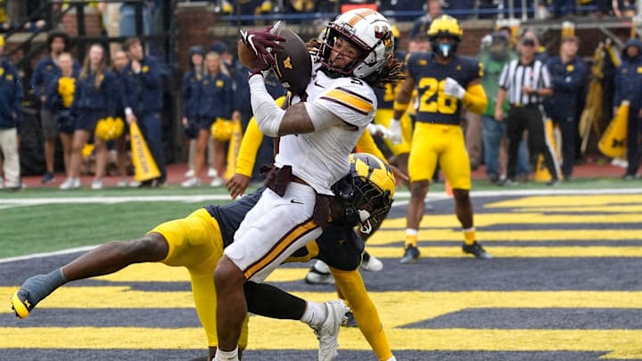 Minnesota wide receiver Daniel Jackson comes down with the touchdown in the end zone with the Michigan defensive back Zeke Berry all over him during first-half action between Michigan and Minnesota at Michigan Stadium in Ann Arbor on Saturday, Sept. 28, 2024. Michigan won the game 27-24 to win the Little Brown Jug that both teams compete for. Minnesota wide receiver Daniel Jackson comes down with the touchdown in the end zone with the Michigan defensive back Zeke Berry all over him during first-half action between Michigan and Minnesota at Michigan Stadium in Ann Arbor on Saturday, Sept. 28, 2024. Michigan won the game 27-24 to win the Little Brown Jug that both teams compete for.