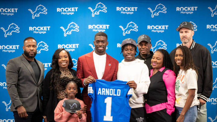 Lions first-round NFL draft pick Terrion Arnold poses for a photo with his family at his introductory press conference.