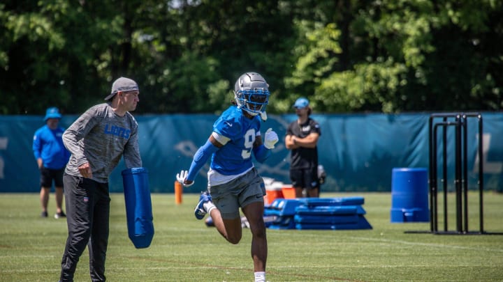 Lions wide receiver Jameson Williams practices his release and catch during the organized team activities in Allen Park on Thursday, May 23, 2024.