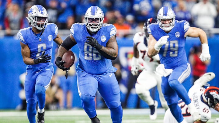 Detroit Lions defensive end Isaiah Buggs runs after recovering a fumble made by Denver Broncos quarterback Russell Wilson during the first half at Ford Field in Detroit on Saturday, Dec. 16, 2023.