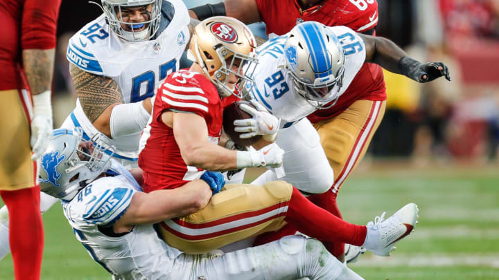 Lions linebacker Jack Campbell tackles 49ers running back Christian McCaffrey.