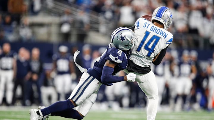 Cowboys cornerback Jourdan Lewis tackles Lions wide receiver Amon-Ra St. Brown. Cowboys cornerback Jourdan Lewis tackles Lions wide receiver Amon-Ra St. Brown.