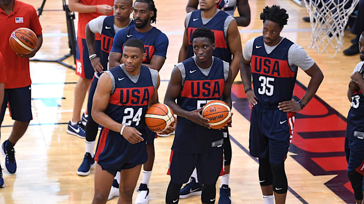 Jul 26, 2018; Las Vegas, NV, USA; Team USA guard Russell Westbrook (24), guard Victor Oladipo (55), and guard DeMar DeRozan (35) listen to head coach Gregg Popovich during the 2018 USA Basketball National Team Minicamp  at Mendenhall Center. Mandatory Credit: Stephen R. Sylvanie-Imagn Images