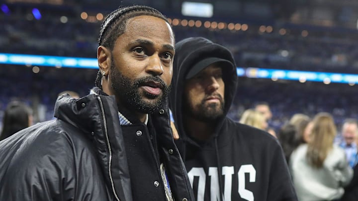 Big Sean and Eminem watch warm up before the NFC wild-card game at Ford Field in Detroit on Sunday, Jan, 14, 2024.