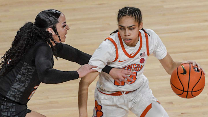 Clemson junior guard Ale'Jah Douglas (24) dribbles near Virginia Tech Kayana Traylor (23) during the