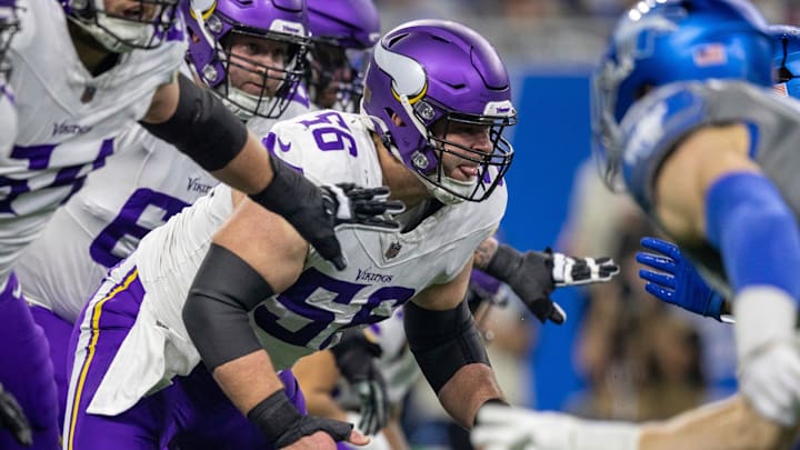 Minnesota Vikings center Garrett Bradbury (56) protects his quarterback during a play against the Detroit Lions defense at Ford Field in Detroit on Sunday, Jan. 7, 2024.