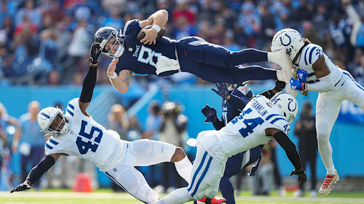 Tennessee Titans quarterback Will Levis (8) scrambles and jumps over Indianapolis Colts linebacker E.J. Speed (45), linebacker Zaire Franklin (44) and cornerback Kenny Moore II (23), on Sunday, Dec. 3, 2023, during NFL week 13 at Nissan Stadium in Nashville, Tenn.