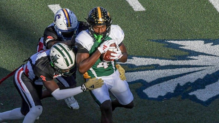 North team receiver Jarel Boulder (4) of Forest Hill High catches a ball near South team Elgin Sessions of Dutch Ford (3) during the fourth quarter of the 2024 Shrine Bowl of the Carolinasat Viking Stadium in Spartanburg, S.C. Saturday, December 21, 2024.