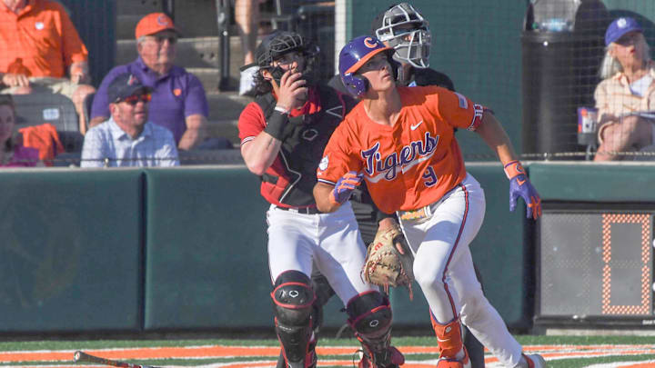 Clemson catcher Jacob Jarrell (9) hits a home run against University of Louisville during the bottom of the fifth inning at Doug Kingsmore Stadum in Clemson, S.C. Friday, April 18, 2025. The home run broke up a no-hitter and helped the Tigers win 2-1.