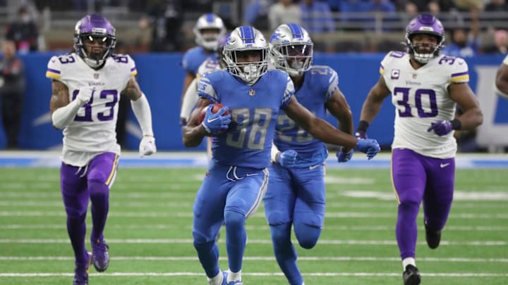 Former Lions safety C.J. Moore runs a fake punt against the Vikings.