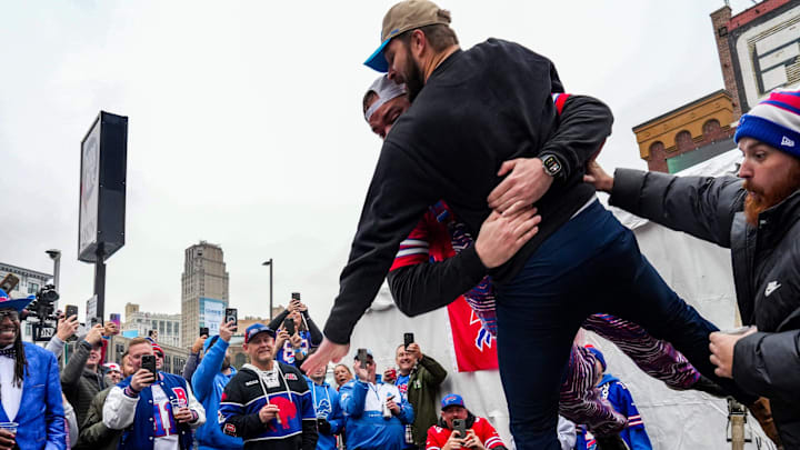 Buffalo Bills fan Alex Cauley, 31, of Kansas City, throws his future groomsmen and Detroit Lions fan Ryan Petras, 31, of Troy through a table at a Buffalo Bills tailgating party in Detroit on Sunday, Dec. 15, 2024.