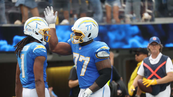Sep 21, 2025; Inglewood, California, USA; Los Angeles Chargers wide receiver Quentin Johnston (1) and Los Angeles Chargers guard Zion Johnson (77) react after a play during the first half against the Denver Broncos at SoFi Stadium. Mandatory Credit: William Navarro-Imagn Images