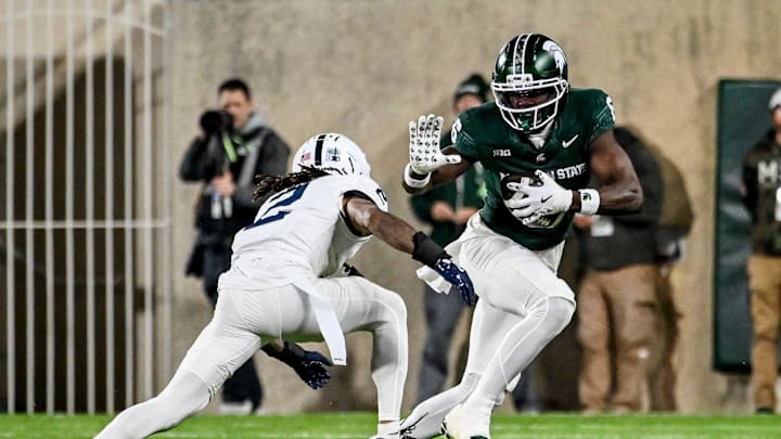 Michigan State's Nick Marsh, right, catches a pass as Penn State's Audavion Collins closes in during the third quarter on Saturday, Nov. 15, 2025, at Spartan Stadium in East Lansing.