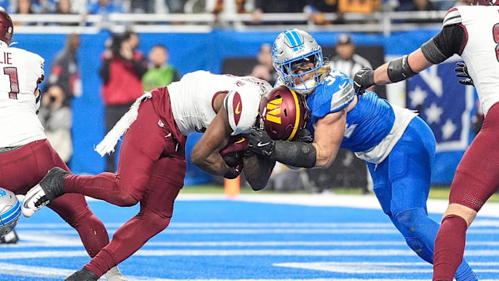 Washington Commanders running back Brian Robinson Jr. runs for a touchdown against Detroit Lions linebacker Alex Anzalone.