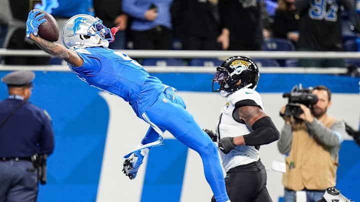 Detroit Lions WR Jameson Williams dives into the end zone to celebrate scoring a touchdown against Jacksonville.