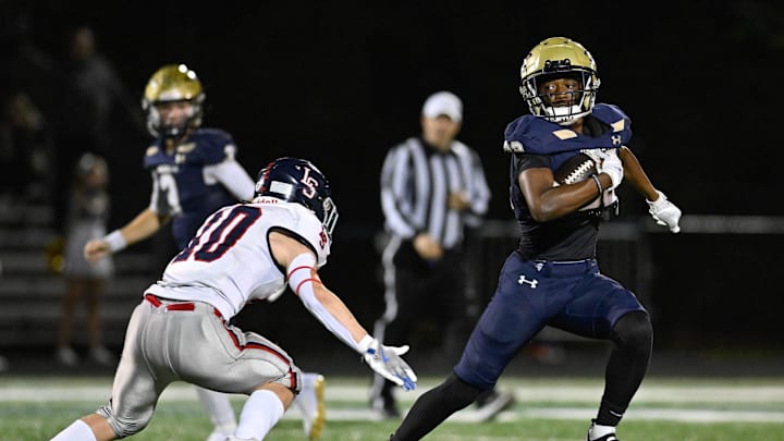 Needham senior JC Andrade runs the ball as Lincoln-Sudbury junior Matthew Tasker attempts a tackle during a game at Myers Field in Sudbury, Friday, Sept. 20, 2024.