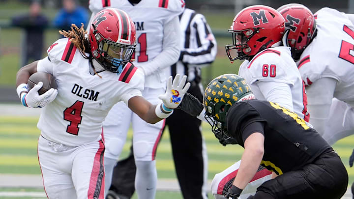 Orchard Lake St. Mary’s wide receiver Bryson Williams runs for extra yardage against the Birmingham Groves defense during first half action between the two schools n the MHSAA Division 2 semifinal game at West Bloomfield High School in West Bloomfield on Saturday, Nov. 23, 2024. Orchard Lake St. Mary’s won the game 28-27 in one overtime.