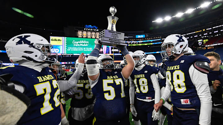 Xaverian senior Peter Matheos celebrates by holding up the Agganis Trophy after defeating Needham, 14-7, in the MIAA Division 1 Super Bowl game at Gillette Stadium, Thursday, Dec. 5, 2024. Xaverian senior Peter Matheos celebrates by holding up the Agganis Trophy after defeating Needham, 14-7, in the MIAA Division 1 Super Bowl game at Gillette Stadium, Thursday, Dec. 5, 2024.