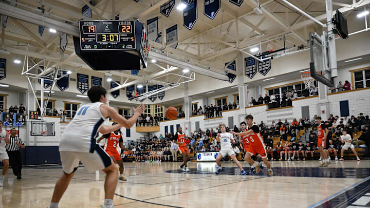 Franklin senior Seth O’Donnell receives a pass during a basketball game against Oliver Ames at Franklin High School, Monday, Dec. 16, 2024. Franklin defeated Oliver Ames, 64-52.