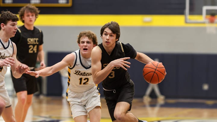 St. Mary Catholic Central's Eddie Keshen drives against Rylan Joerin of Whiteford during a 53-35 SMCC win in the finals of the Division 3 District at Whiteford on Friday, Feb. 28, 2025.
