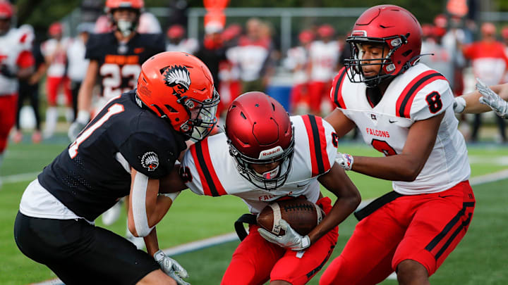 East Kentwood wide receiver Reginald Brown (3), center, caches a pass for a first down against East Kentwood during the first half at Lawrence Tech in Southfield on Friday, Sept. 3, 2021.