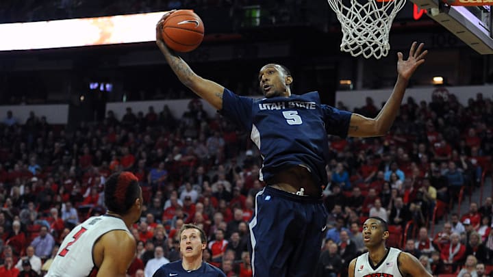Jan 22, 2014; Las Vegas, NV, USA; Utah State Aggies center Jarred Shaw (5) jumps to grab a rebound during an NCAA men's basketball game against the UNLV Runnin' Rebels at Thomas & Mack Center. Mandatory Credit: Stephen R. Sylvanie-Imagn Images