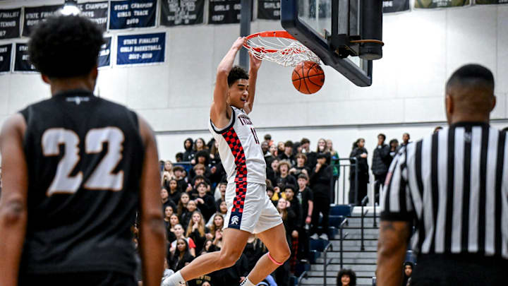 East Lansing's KT Thomas dunks against Waverly during the fourth quarter on Thursday, Dec. 18, 2025, at East Lansing High School.