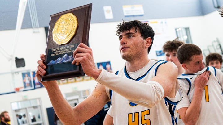 Timnath's Max Roselle holds up the state qualifier trophy after winning a Colorado Class 4A high school basketball playoff game vs. Eagle Ridge Academy on March 7, 2026, at Timnath Middle-High School in Timnath, Colo.