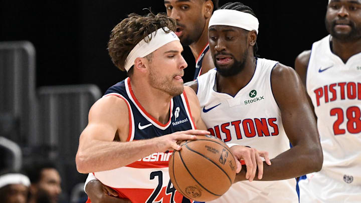 Oct 16, 2025; Detroit, Michigan, USA; Washington Wizards forward Corey Kispert (24) tries to drive past Detroit Pistons guard Caris Levert (8) in the first quarter at Little Caesars Arena. Mandatory Credit: Lon Horwedel-Imagn Images