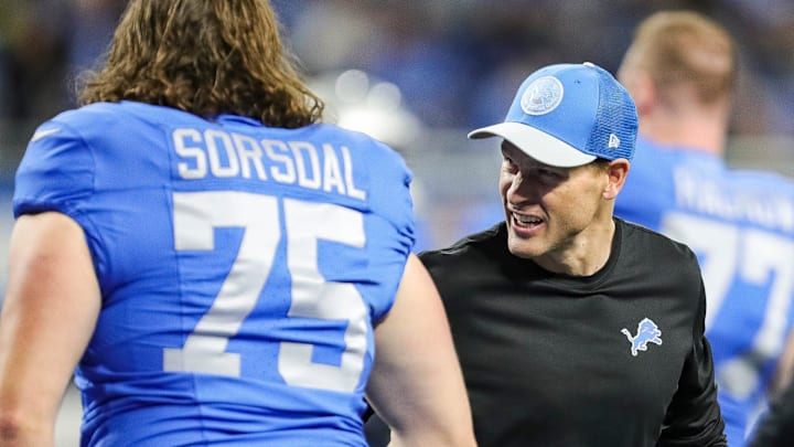 Detroit Lions offensive coordinator Ben Johnson shakes hands with rookie offensive lineman Colby Sorsdal during warmups before the game against the Green Bay Packers at Ford Field in Detroit on Thursday, Nov. 23, 2023.