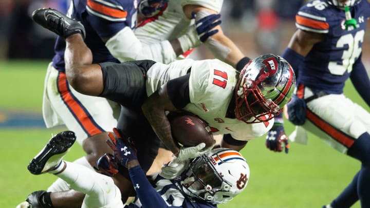 Auburn Tigers cornerback Nehemiah Pritchett (18) stops Western Kentucky Hilltoppers wide receiver Malachi Corley (11) as Auburn Tigers take on Western Kentucky Hilltoppers at Jordan-Hare Stadium in Auburn, Ala., on Saturday, Nov. 19, 2022.