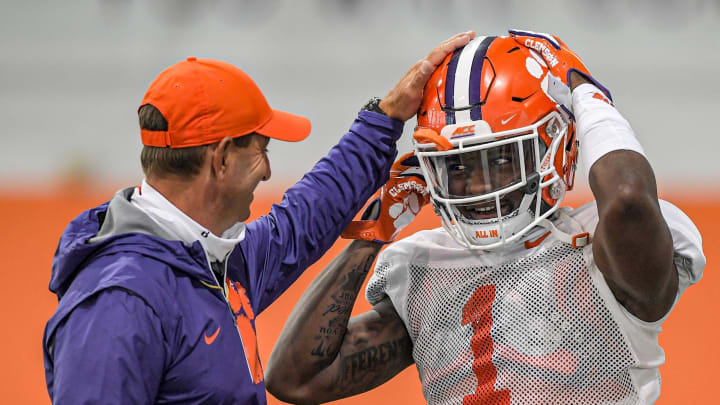Clemson head coach Dabo Swinney smiles with safety Andrew Mukuba (1) during football practice in Clemson, S.C. Monday, March 22, 2021.