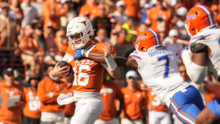 Texas Longhorns quarterback Arch Manning (16) shakes off a tackle attempt from Florida Gators defensive back Trikweze Bridges (7) during the Longhorns' game against the Florida Gators, Nov. 9, 2024 at Darrell K. Royal Texas Memorial Stadium in Austin.