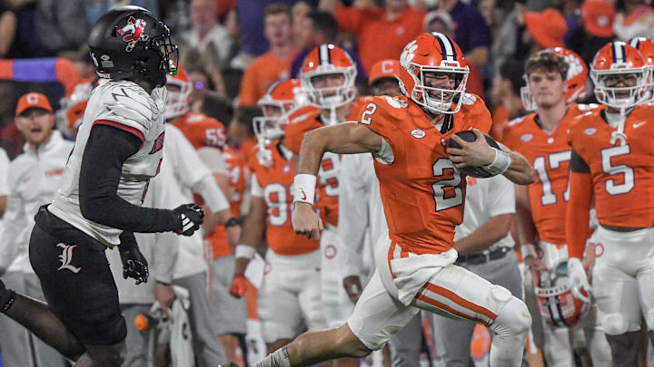 Nov 2, 2024; Clemson, South Carolina, USA; Clemson Tigers quarterback Cade Klubnik (2) runs against Louisville Cardinals linebacker Stanquan Clark (6) during the second quarter at Memorial Stadium. Mandatory Credit: Ken Ruinard-Imagn Images