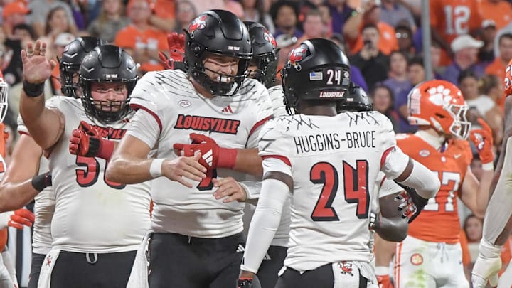 Nov 2, 2024; Clemson, South Carolina, USA; Louisville Cardinals quarterback Tyler Shough (9) celebrates with receiver Ahmari Huggins-Bruce (24) after scoring against the Clemson Tigers during the second quarter at Memorial Stadium. Mandatory Credit: Ken Ruinard-Imagn Images