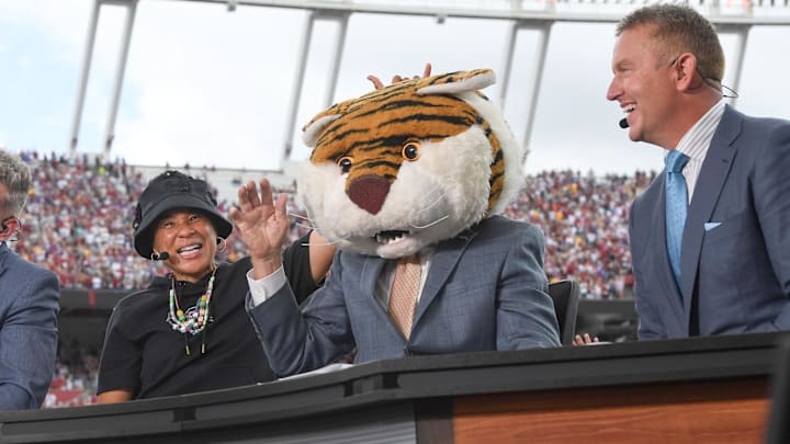 Sep 14, 2024; Columbia, South Carolina, USA; South Carolina Gamecocks basketball coach Dawn Staley (left)  smiles after Lee Corso picked LSU and she picked South Carolina to win during the ESPN Gameday show before kickoff of a football game at Williams-Brice Stadium. Mandatory Credit: Ken Ruinard/USA TODAY Network via Imagn Images