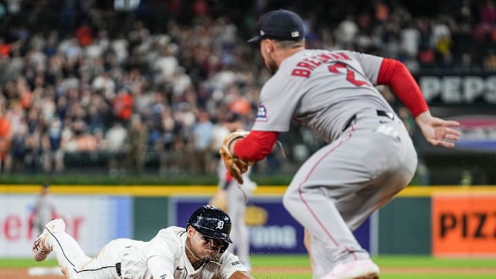 Detroit Tigers' Andy Ibáñez slides into third base against the Boston Red Sox's Alex Bregman during the ninth inning at Comerica Park on May 14, 2025.