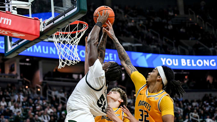 Michigan State's Coen Carr, left, shoots as Toledo's London Praytor, center, and Jaylan Ouwinga defend during the second half on Tuesday, Dec. 16, 2025, at the Breslin Center in East Lansing.