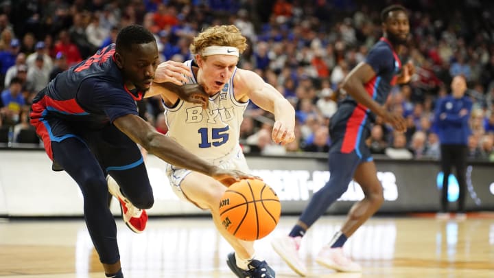 Mar 21, 2024; Omaha, NE, USA; Duquesne Dukes forward Fousseyni Drame (34) and Brigham Young Cougars