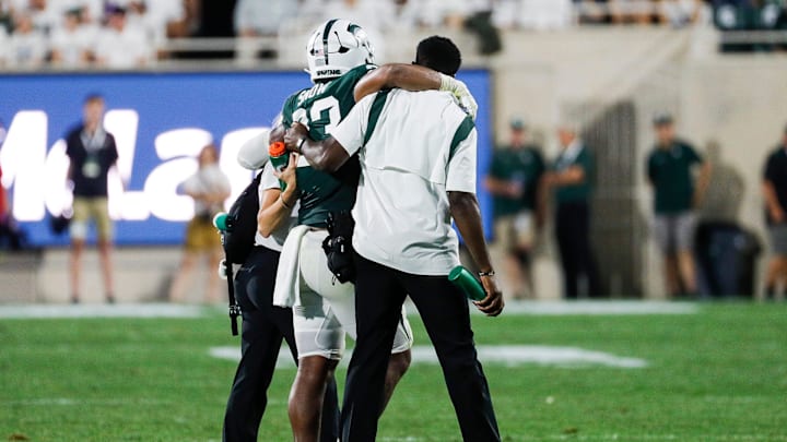 Michigan State linebacker Darius Snow (23) is carried off the field during the first half against
