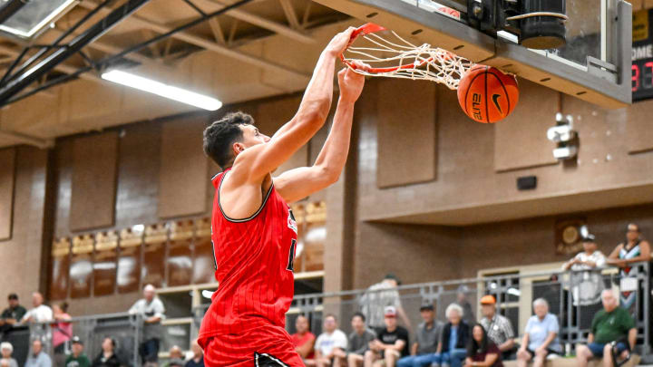 Team Goodfellas' and Michigan State's Szymon Zapala dunks against Team Motorcars in the game on Tuesday, July 9, 2024, during the Moneyball Pro-Am at Holt High School.