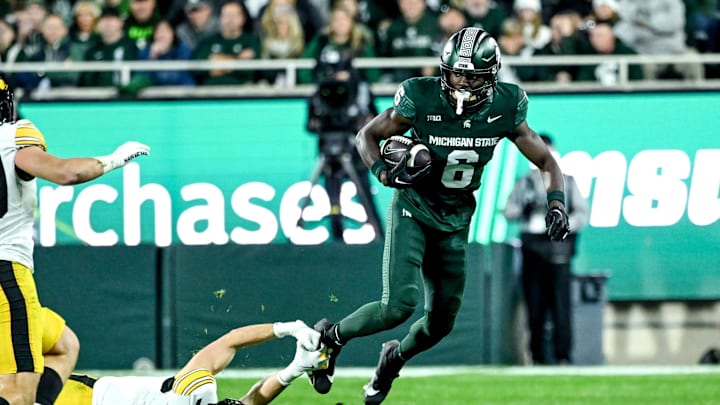 Michigan State's Nick Marsh, right, breaks a tackle attempt by Iowa's John Nestor during the third quarter on Saturday, Oct. 19, 2024, at Spartan Stadium in East Lansing.