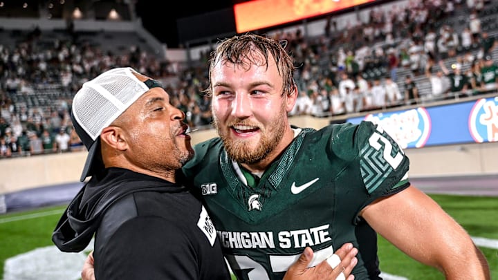 Michigan State's Cal Haladay, right, celebrates with defensive backs coach Demetrice Martin after the Spartans win over Florida Atlantic on Friday, Aug. 30, 2024, at Spartan Stadium in East Lansing.