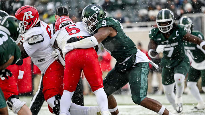 Michigan State's Jalen Thompson, right, tackles Rutgers' Kyle Monangai during the first quarter on Saturday, Nov. 30, 2024, at Spartan Stadium in East Lansing.