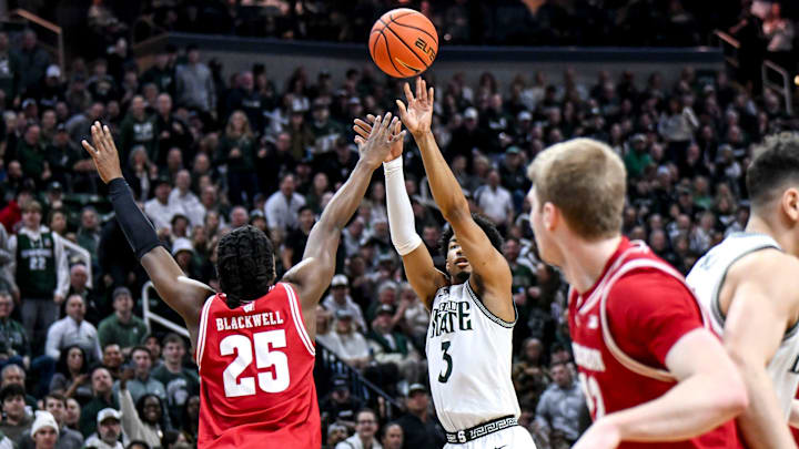 Michigan State's Jaden Akins, right, scores against Wisconsin's John Blackwell during the first half on Sunday, March 2, 2025, at the Breslin Center in East Lansing.